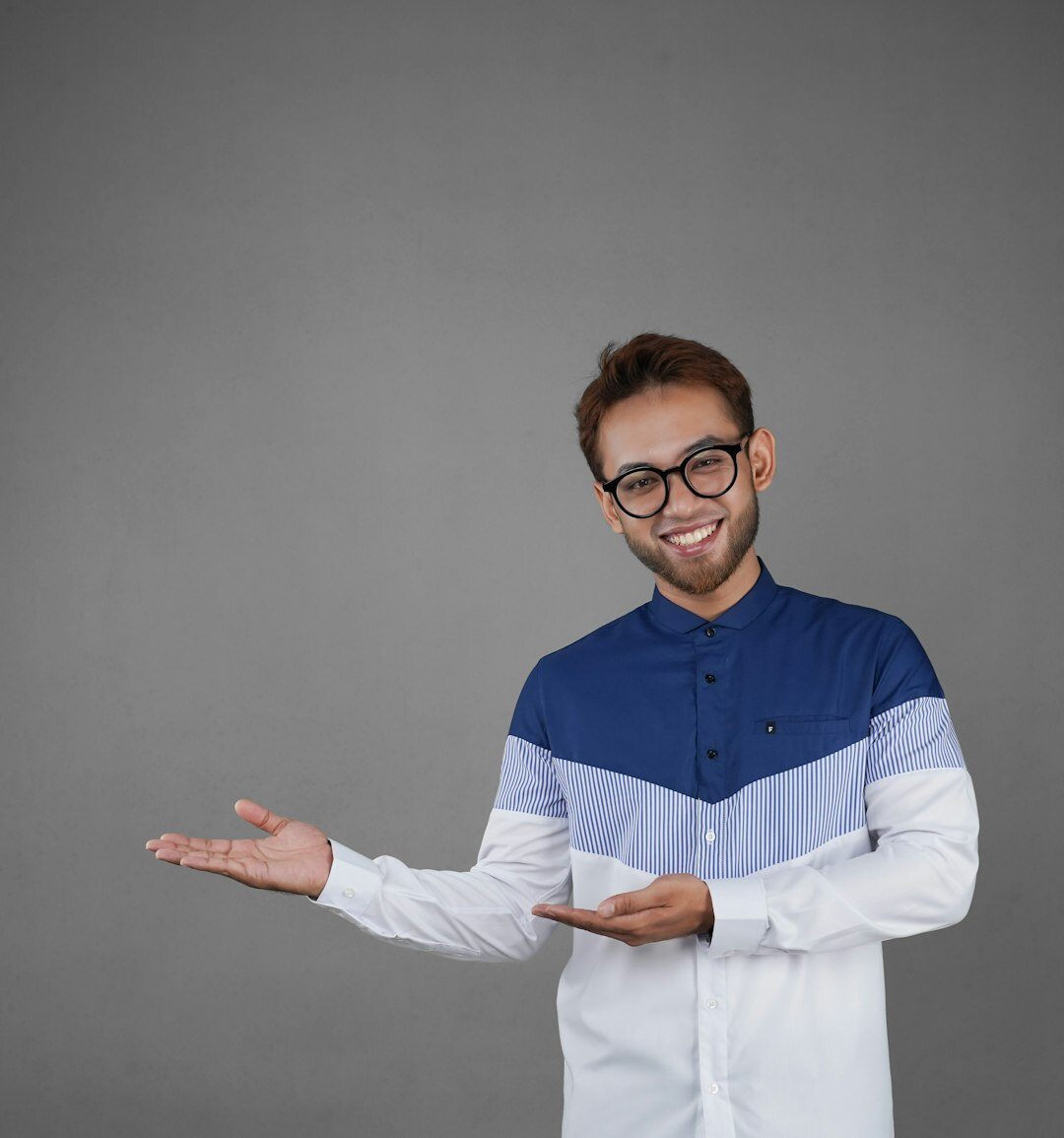Professional portrait of a young European man with a warm smile in a casual business look