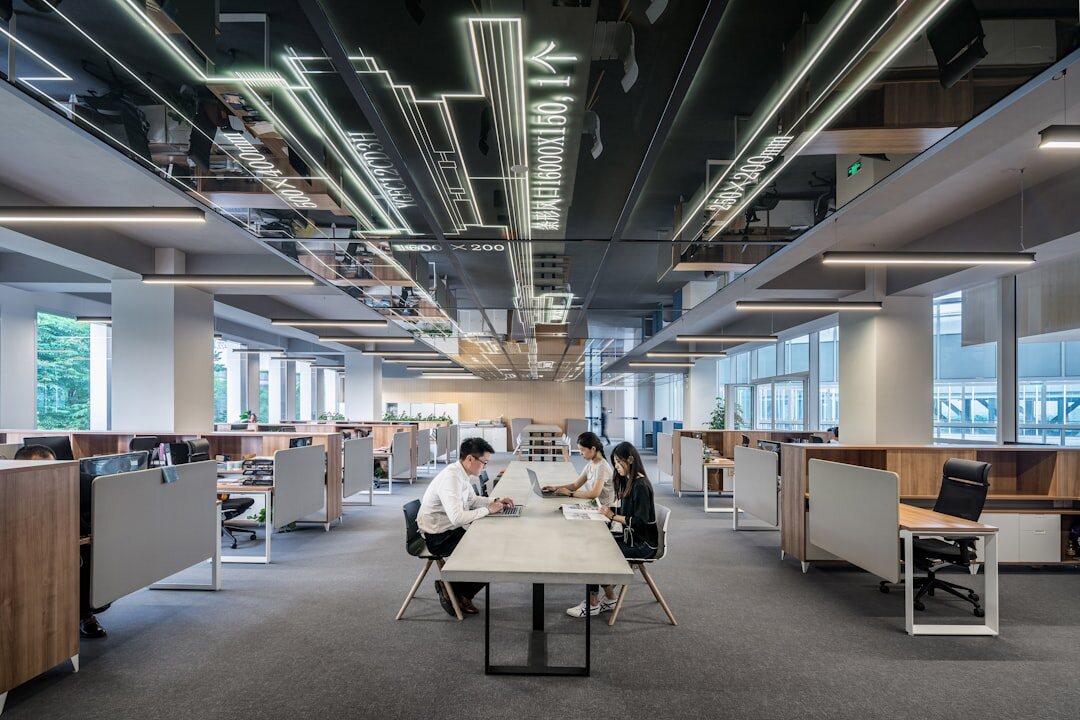 Modern open-plan tech startup office with bright lighting and team members working